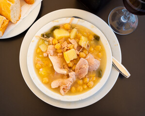 Delicious boiled chickpeas served with meat on plate in restaurant
