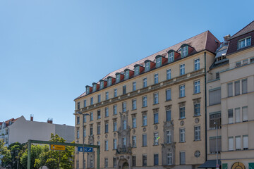Fototapeta premium A classic Berlin residential building with dormer windows and ornate facade details. The blue sky highlights the structure.