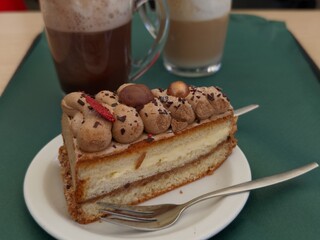 Delicious chocolate cake slice with coffee and latte for a sweet indulgence