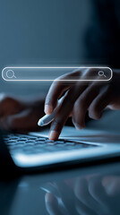 Person's hand using a stylus to type on a laptop keyboard with a glowing search bar interface typing