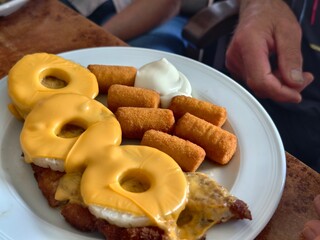 Plate of cordon bleu with pineapple rings and croquettes for a delicious meal