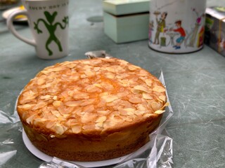 Almond cake dessert with coffee mugs for a delicious treat or bakery concept