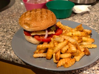 Delicious burger with french fries on a plate ready to be served and enjoyed