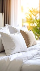 White bedding and pillows in a bright room