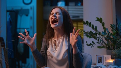 Angry furious Caucasian woman girl at home scream desperate yelling shouting night evening...