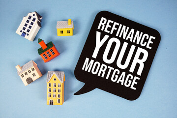 Refinance Your Mortgage text with house models on blue background