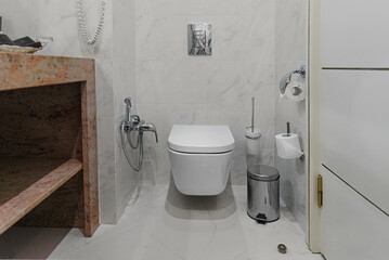 Bathroom in gray and white tones with dim lighting