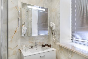 Bathroom in gray and white tones with dim lighting