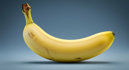 Single ripe banana on blue gradient warm tones meet cool backdrop, evoking freshness, contrast, and quiet abundance.