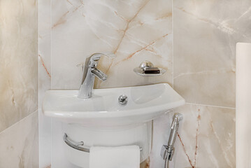 Bathroom in gray-beige tones with dim lighting