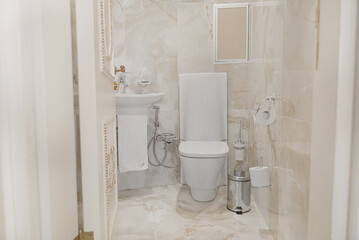Bathroom in gray-beige tones with dim lighting