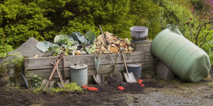 Garden compost heap with gardening tools and equipment.