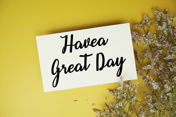 Have a Great Day text with flowers decoration on yellow background