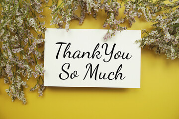 Thank you so much text with flowers decoration on yellow background