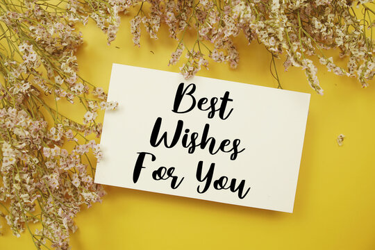 Best Wishes For You text with flowers decoration on yellow background