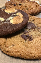 Assorted cookies on wooden surface with chocolate chips and marshmallows concept of bakeries and cafes