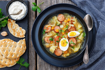 Polish sauerkraut soup with sausage in a bowl