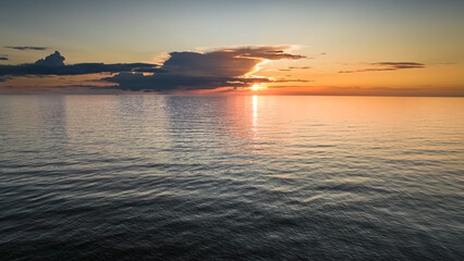 Calm sunbeams over sea at sunset in Poland.