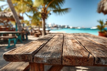 Rustic wooden table in focus with blurred beach background, palm trees, and ocean. Sunshine on a clear day