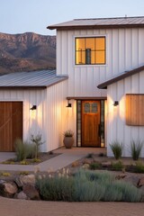 Modern architectural design of a home in the mountains featuring a warm entrance and clean lines at dusk with soft lighting enhancing the exterior