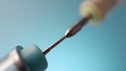 Macro photo of a medical syringe needle on a soft blue background, A magnified close-up of a hypodermic needle for medical or cosmetic injection Thin metal needle used for vaccination or blood testing