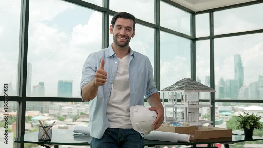Poster smiling architect engineer take off safety helmet while giving thumb up. skilled manager looking at 