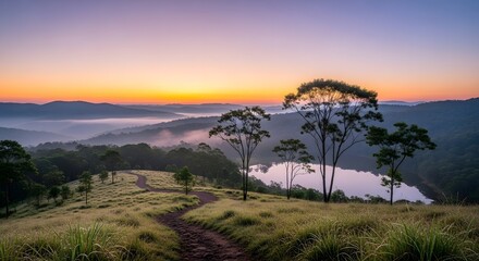 Breathtaking sunrise over a misty mountain landscape with trees and a winding path