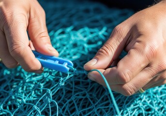 Fisherman hands repairing a fishing net with a shuttle tool close up of manual labor and traditional craft