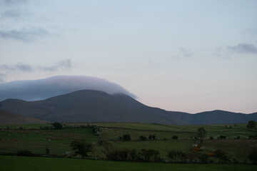 Twilight Over Mist-Capped Mountains and Peaceful Pastures