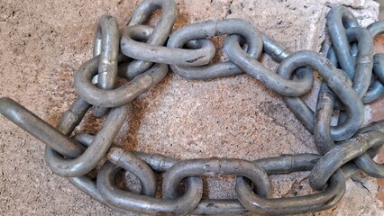 Close-up of a heavy metal chain with a rusty texture