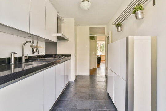 Modern kitchen with sleek white cabinets and decor