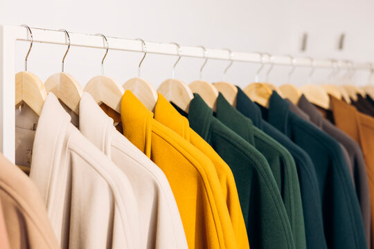 Colorful autumn coats on hangers in a store display