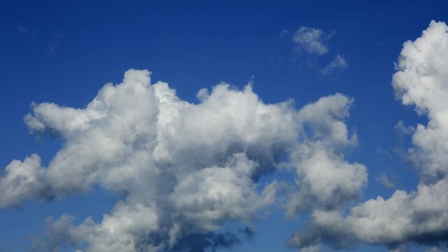 Blue sky white clouds. Puffy fluffy white clouds. Cumulus cloud cloudscape timelapse. Storm Clouds Time lapse.