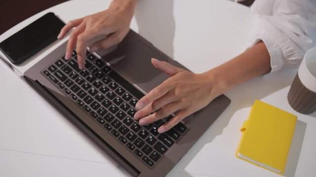 woman working from home at her desk opens laptop computer top view overhead shot,zoom out of businesswoman opening notebook and start typing writes email surfs the internet drinks coffee
