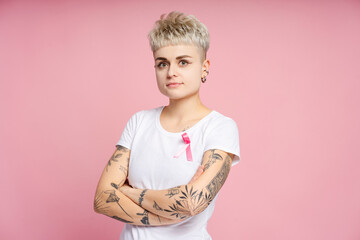 Young woman with pink ribbon supporting breast cancer awareness