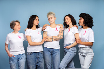 Diverse women embracing and supporting breast cancer awareness