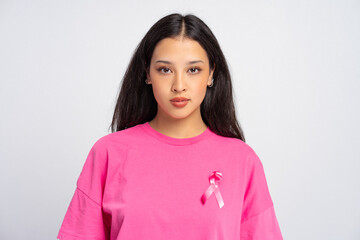 Young Asian woman wearing pink ribbon supporting breast cancer awareness