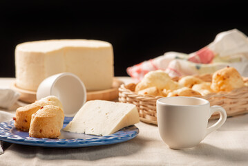 Cheese bread, table with coffee cheese bread and semi-cured cheese from Brazil, selective focus.