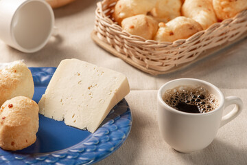 Cheese bread, table with coffee cheese bread and semi-cured cheese from Brazil, selective focus.