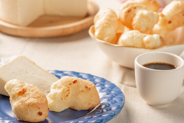 Cheese bread, table with coffee cheese bread and semi-cured cheese from Brazil, selective focus.