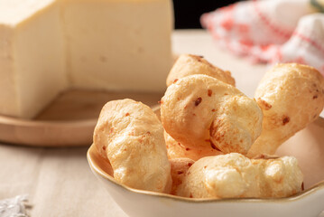 Cheese bread, table with cheese bread and semi-cured cheese from Brazil, selective focus.