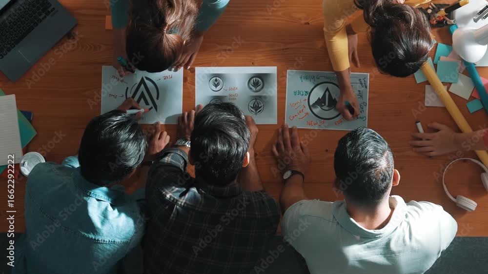 Poster top view of smart business team put graphic logo on meeting table and start to design while explain 