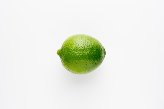 Fresh bright green lime on a white background.