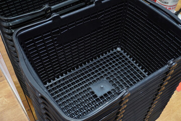 Black shopping basket in shopping center.