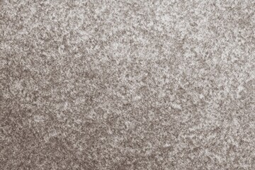 Textured close-up of gray and white snowy surface pattern
