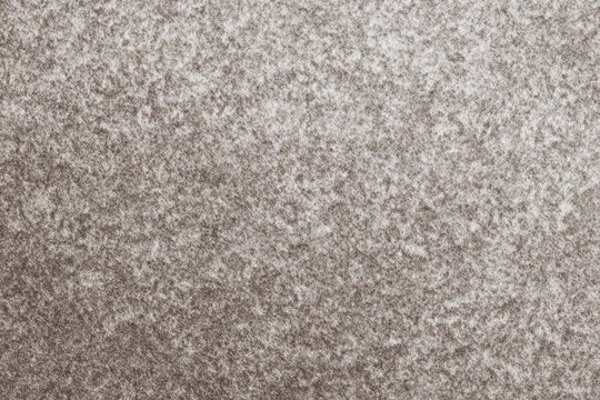 Textured close-up of gray and white snowy surface pattern