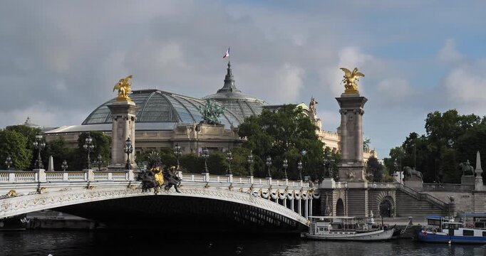 The pont Alexandre III over crossing the river Seine. In the background is the Grand Palais. Paris, France