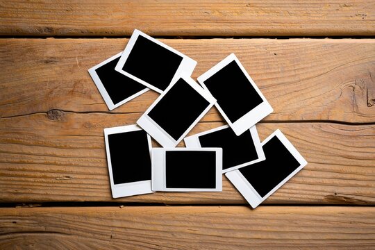 Set of old photos on weathered wooden backdrop.