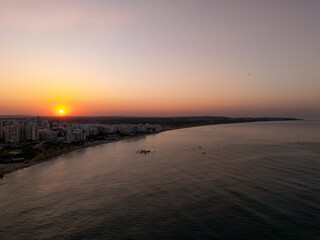 Fototapeta premium Sunrise over Praia da Rocha beach and skyline, Portimão, Algarve, Portugal