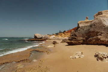 Sandy shore and coastal cliffs at Praia dos Três Castelos, Algarve, Portugal